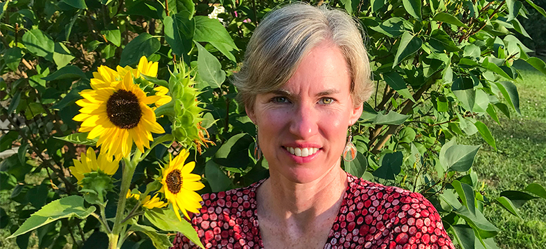 Professor Croteau pictured with Sunflowers