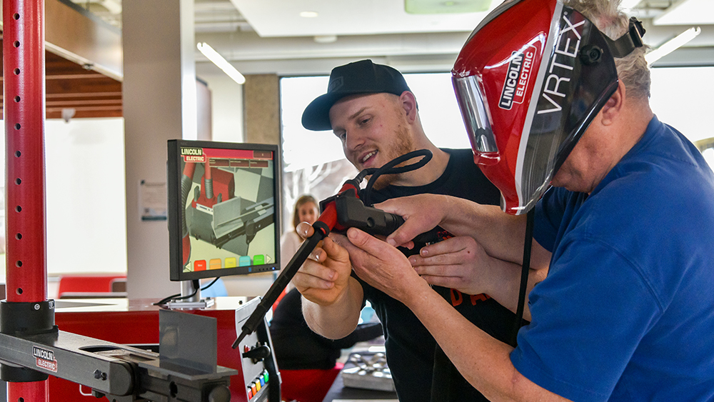 Mark Bellinger helping perform a VR welding session.